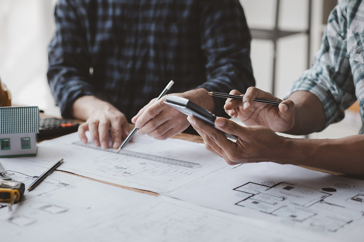 The home design architects are reviewing the house plan draft, t